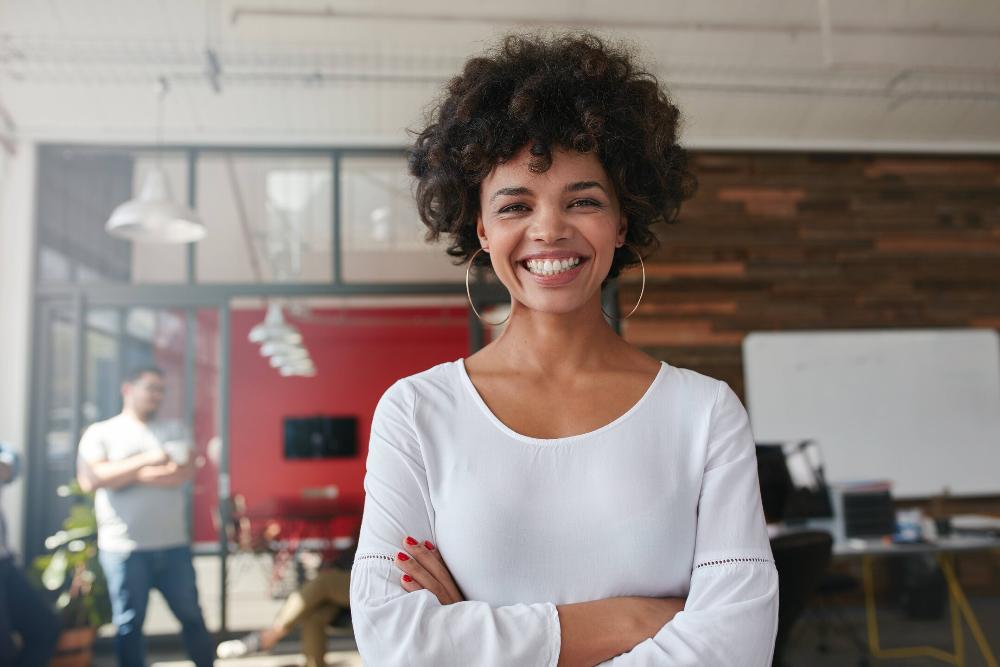 woman smiling while standing in an office