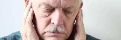 man holding jaw from tooth pain due to TMJ