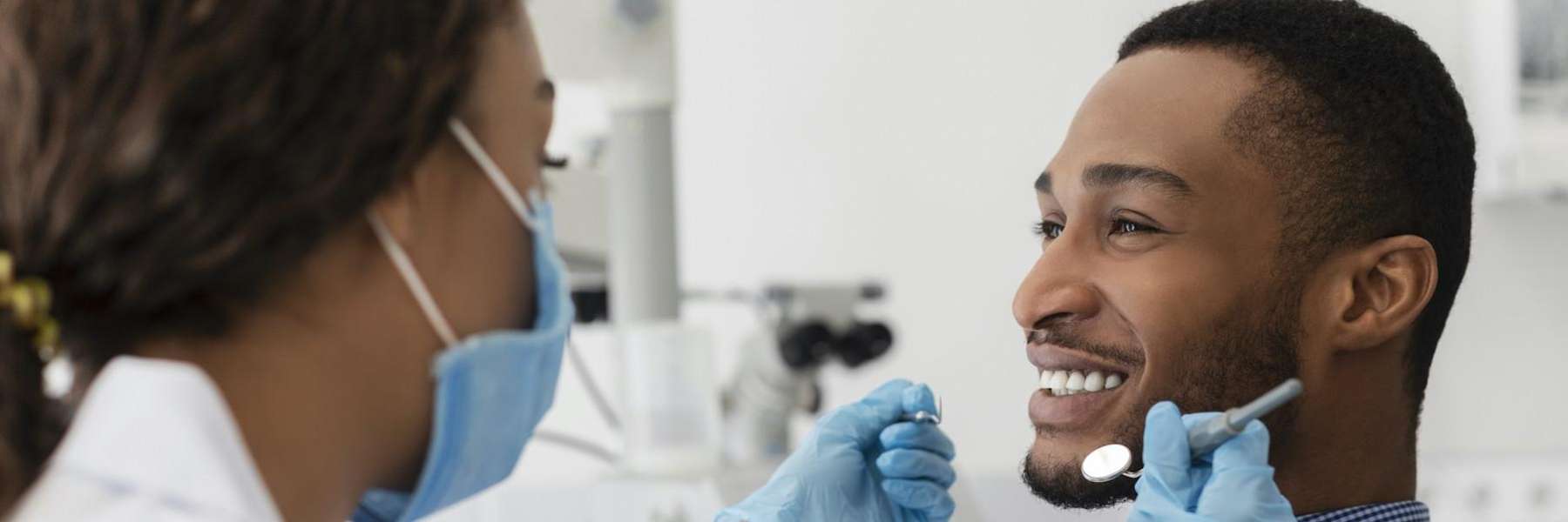 dentist consulting smiling patient | tooth-colored fillings in Phoenix
