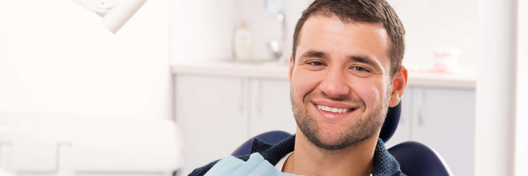 man receiving dental bridge replacement in Phoenix