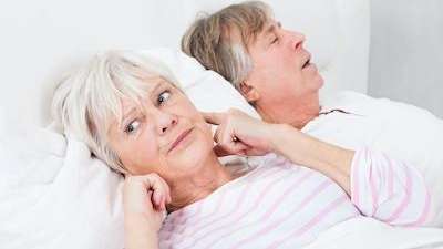 woman covering her ear