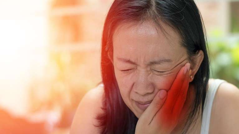 female in pain from a toothache