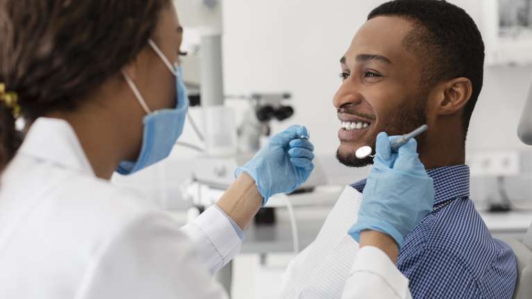 man smiling while getting a dental crown in arcadia az