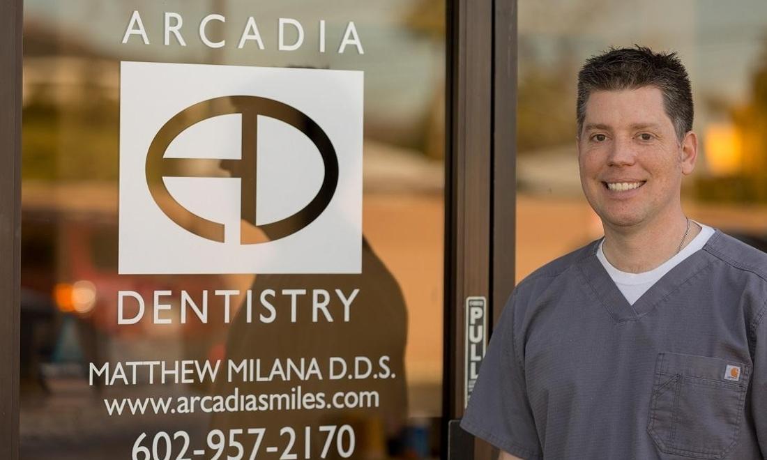 Dr. Matthew Milana Dr. Milana Mathew, smiling outside of Arcadia Dentistry in Phoenix